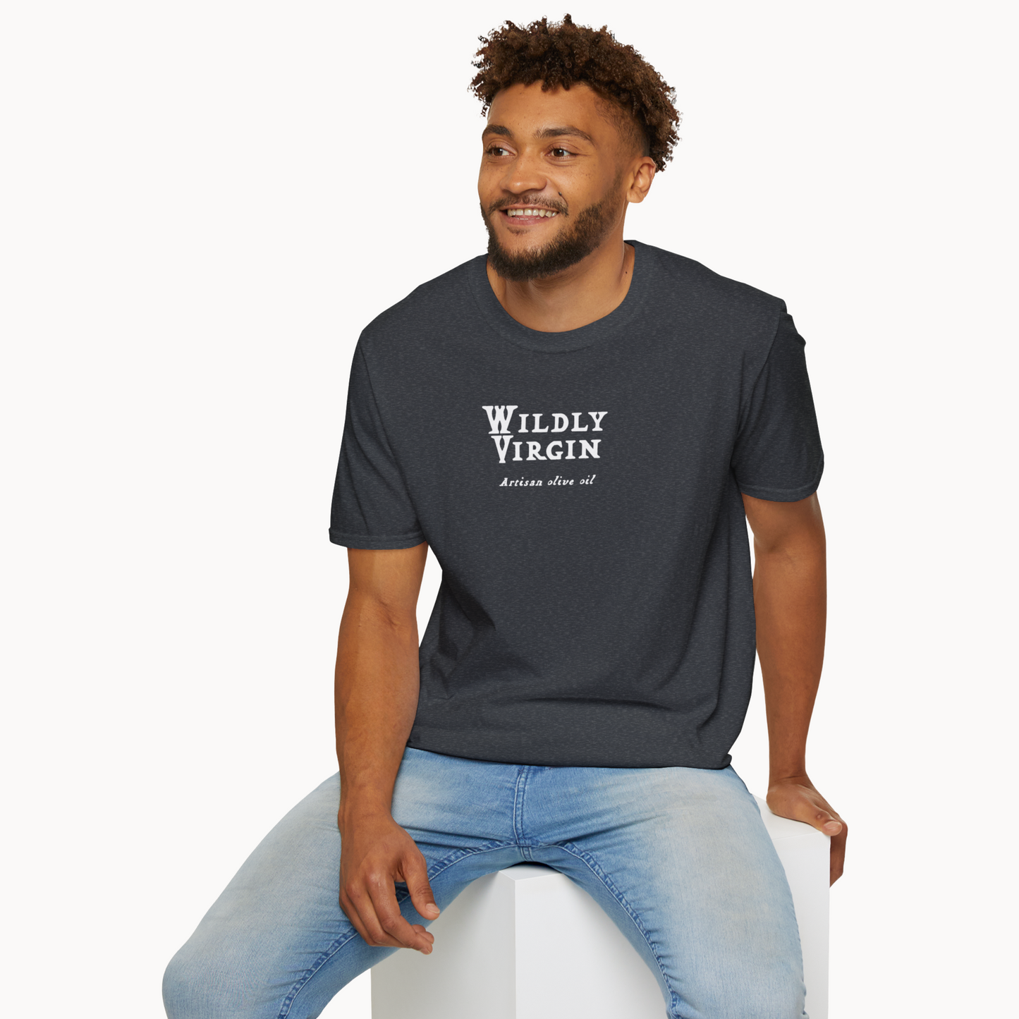 Man wearing a Wildly Virgin artisan olive oil t-shirt, showcasing a stylish design in a casual setting.