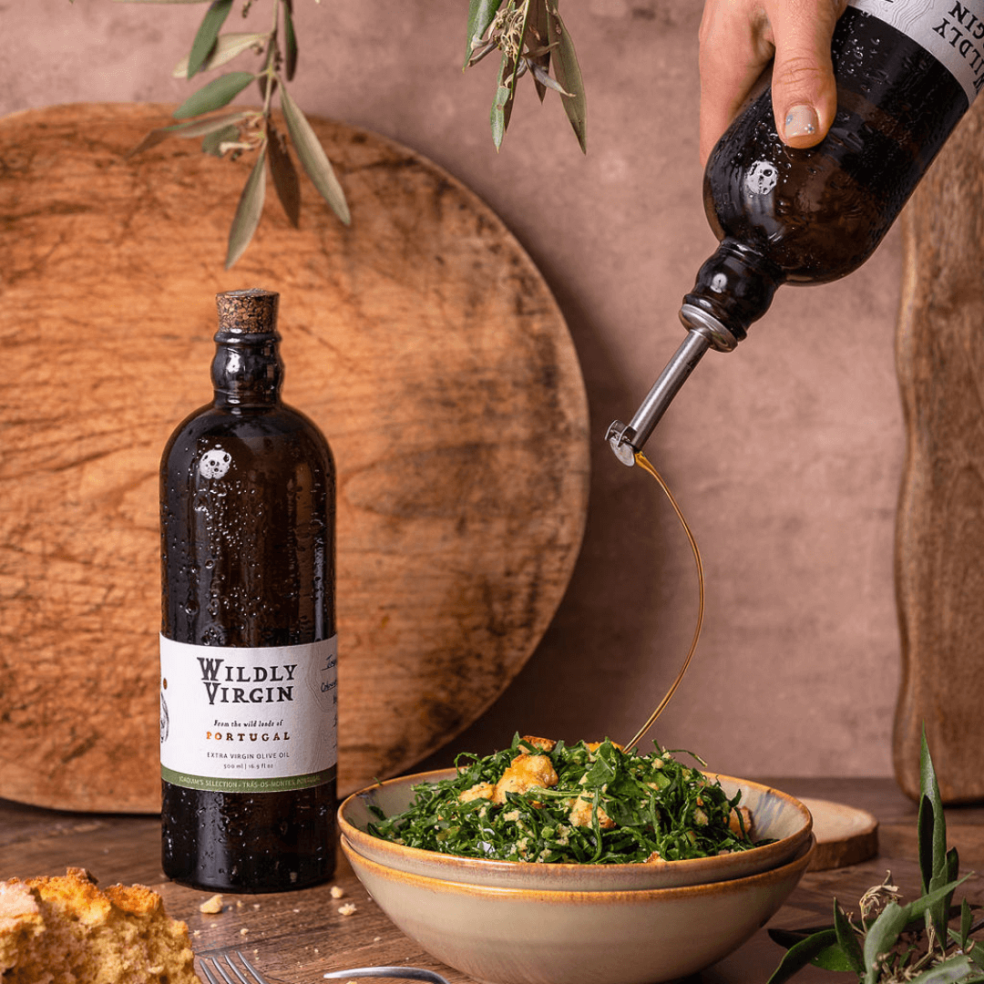 pouring evoo over salad