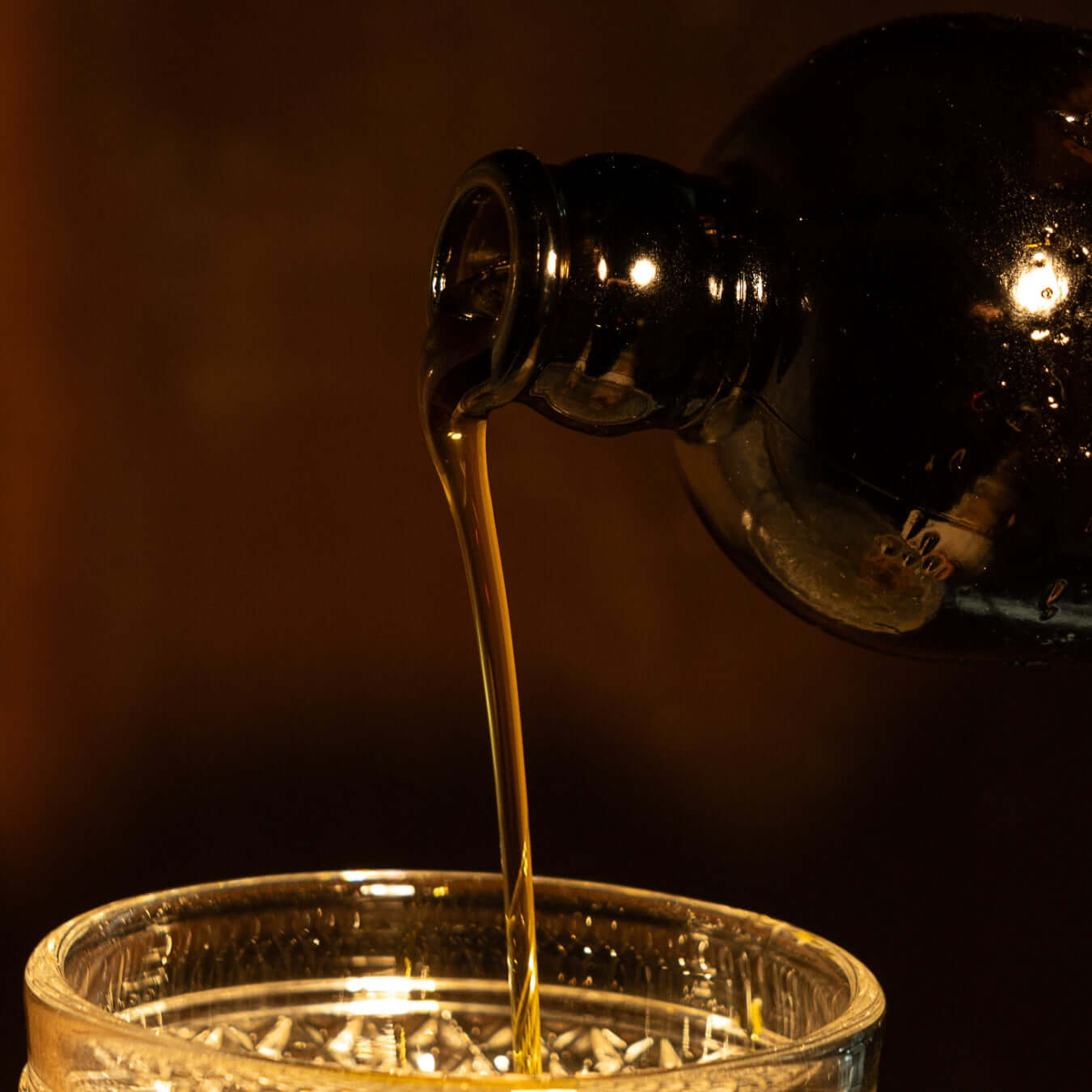 pouring evoo into glass