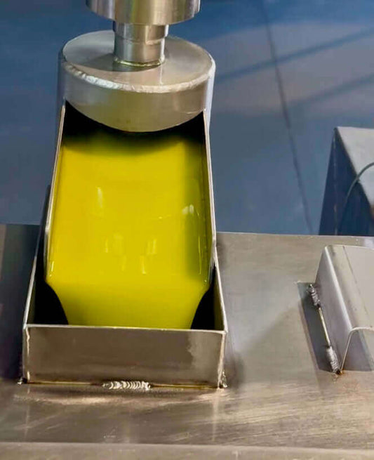 Fresh Olive Oil flowing from a mill