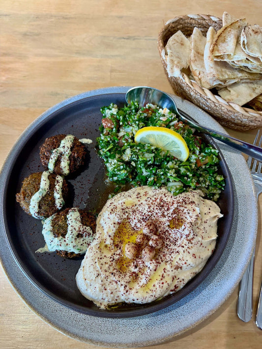 creamy hummus on plate with falafel