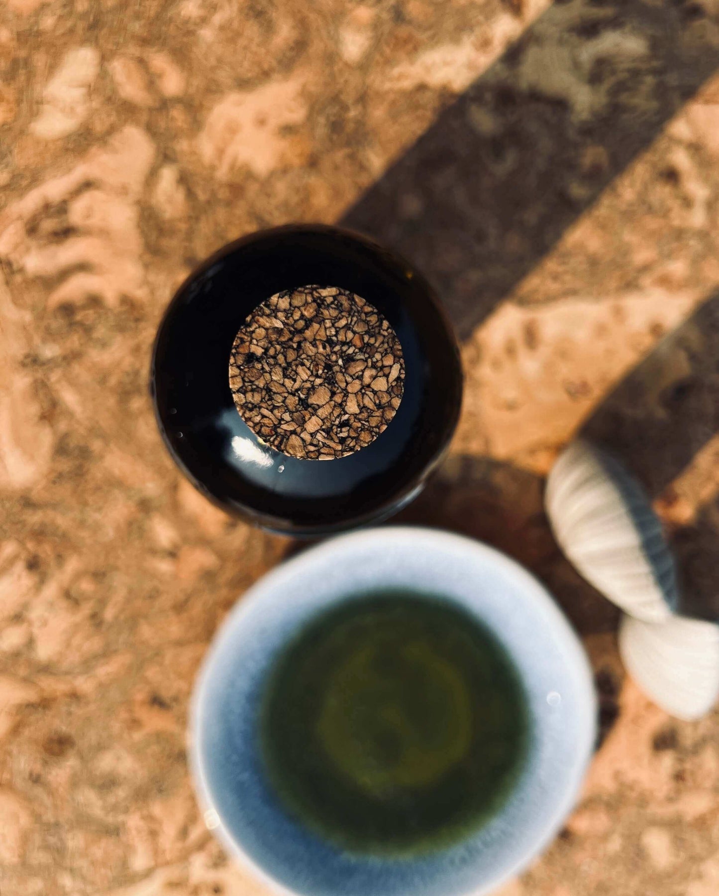 A close up photo looking down on the cork stopper next to olive oil and salt