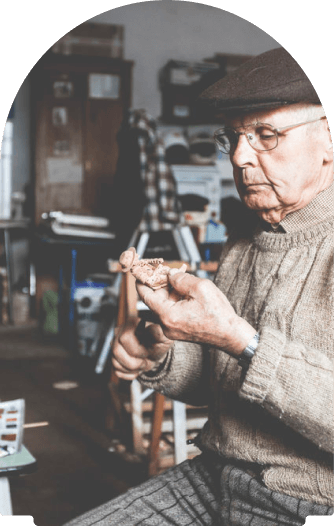 A Portuguese craftsmen whittling a small cork figure