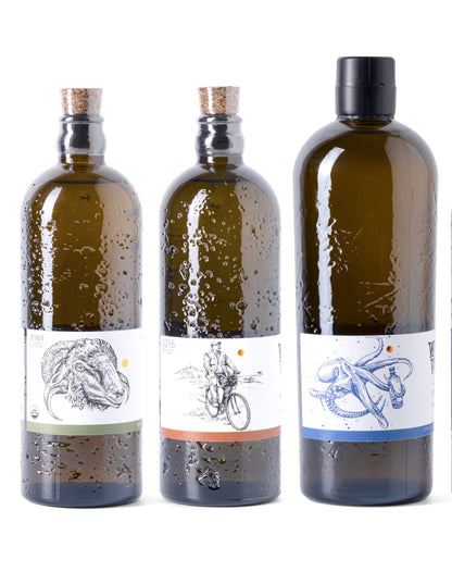Three bottles with unique labels featuring artistic designs on a white background