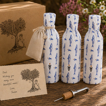 Three bottles of Wildly Virgin olive oil with sardine gift tissue paper, a box, a card, and a cork spout on a wooden surface.