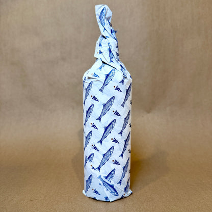 Artfully wrapped bottle featuring blue fish design, showcasing a unique packaging style.