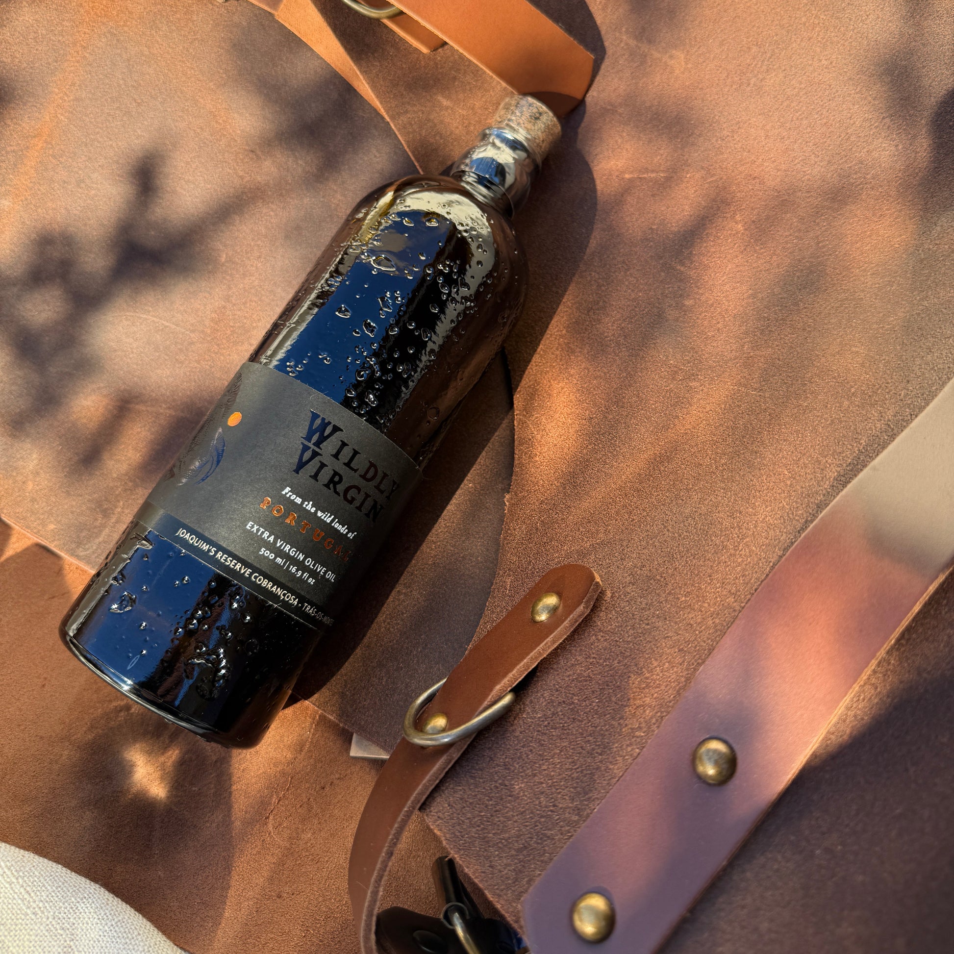 The Porto Collection featuring Joaquim’s Reserve olive oil bottle on soft brown leather.