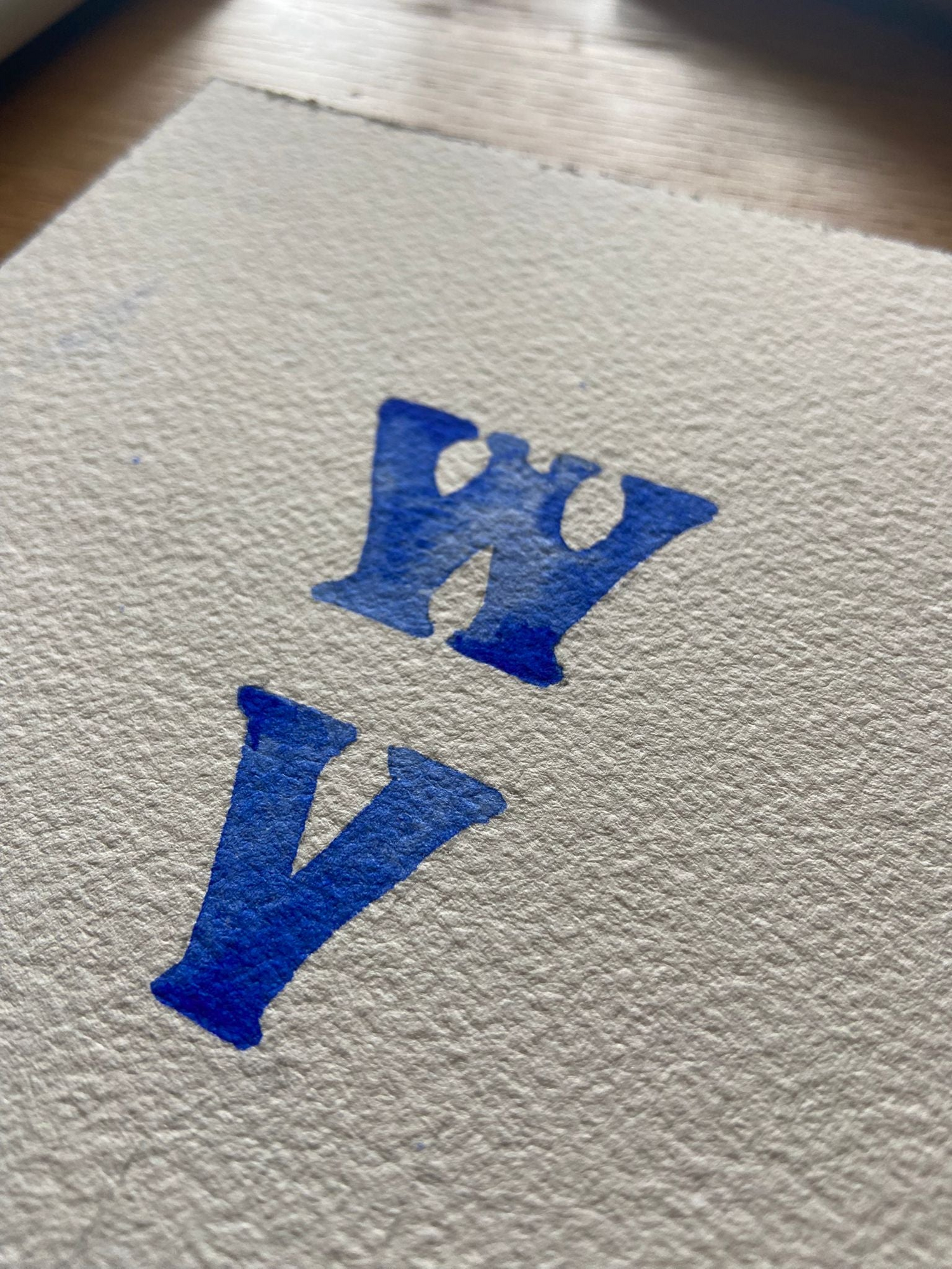 Watercolor painting of the Wildly Virgin logo in blue