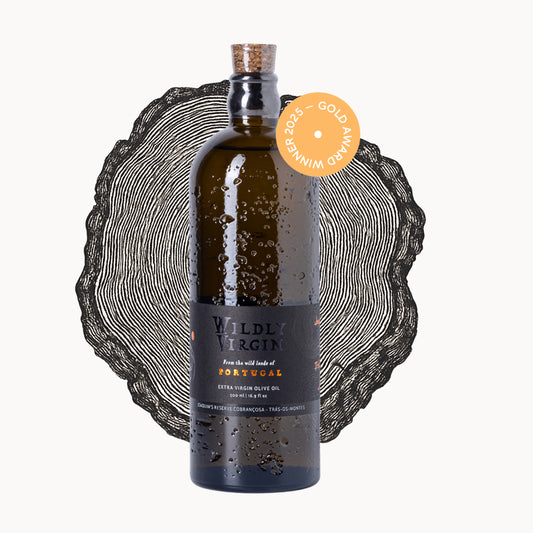Bottle of Wildly Virgin extra virgin olive oil from Portugal, winner of the 2023 Gold Award, with a decorative background.