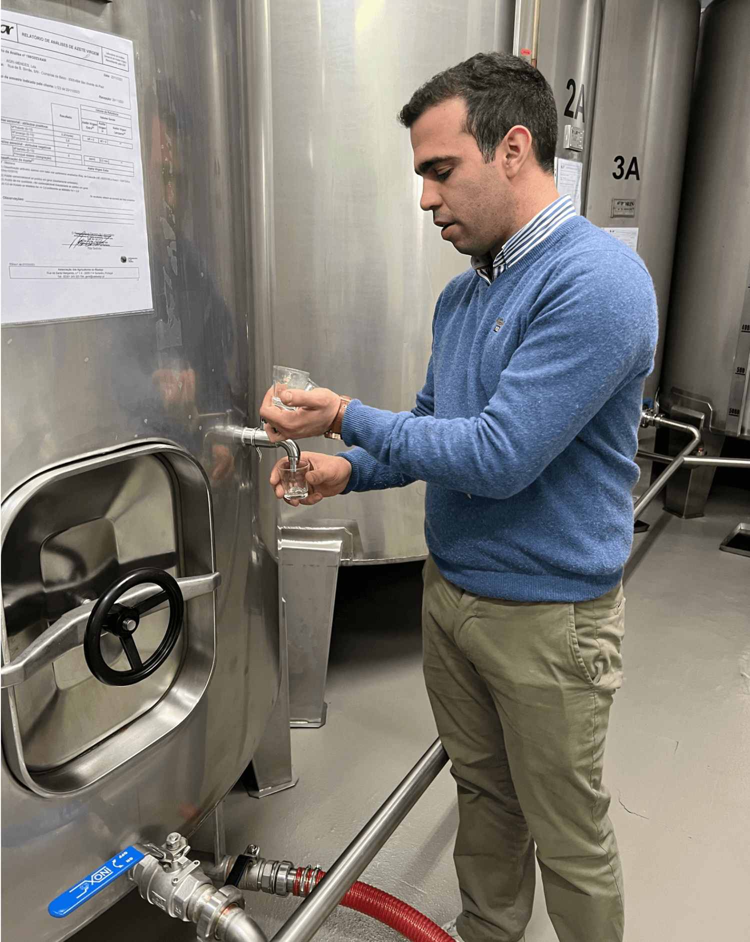 Joao filling tasting cups with fresh olive oils to try