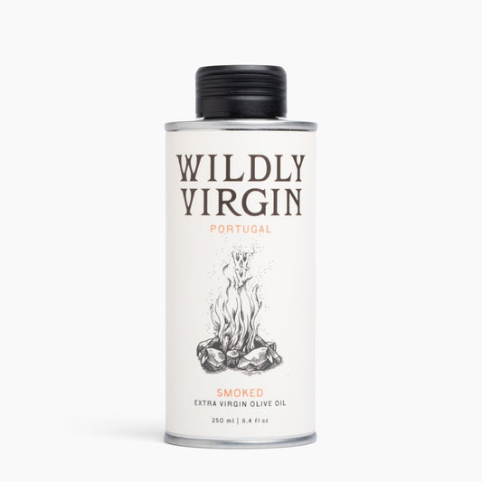 A 250ml metal can of Wildly Virgin Smoked Extra Virgin Olive Oil from Portugal, featuring a white label with a black cap and a campfire illustration.