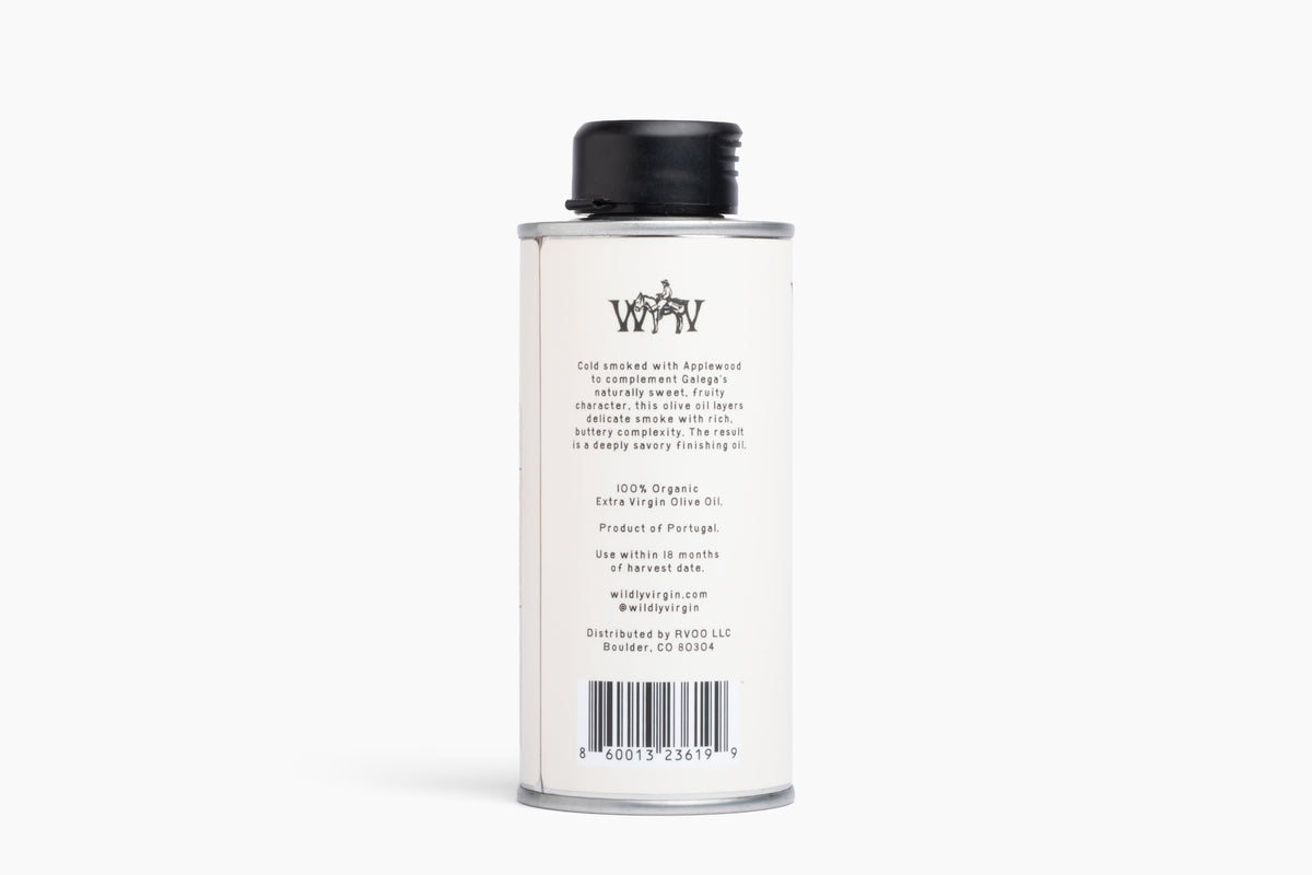 A tall, slender white metal canister with a black screw cap, shown from the back against a clean white background. The label features the stylized 'WY' logo and product details in black text, including 'Cold Water' and '100% Organic Extra Virgin Olive Oil'.