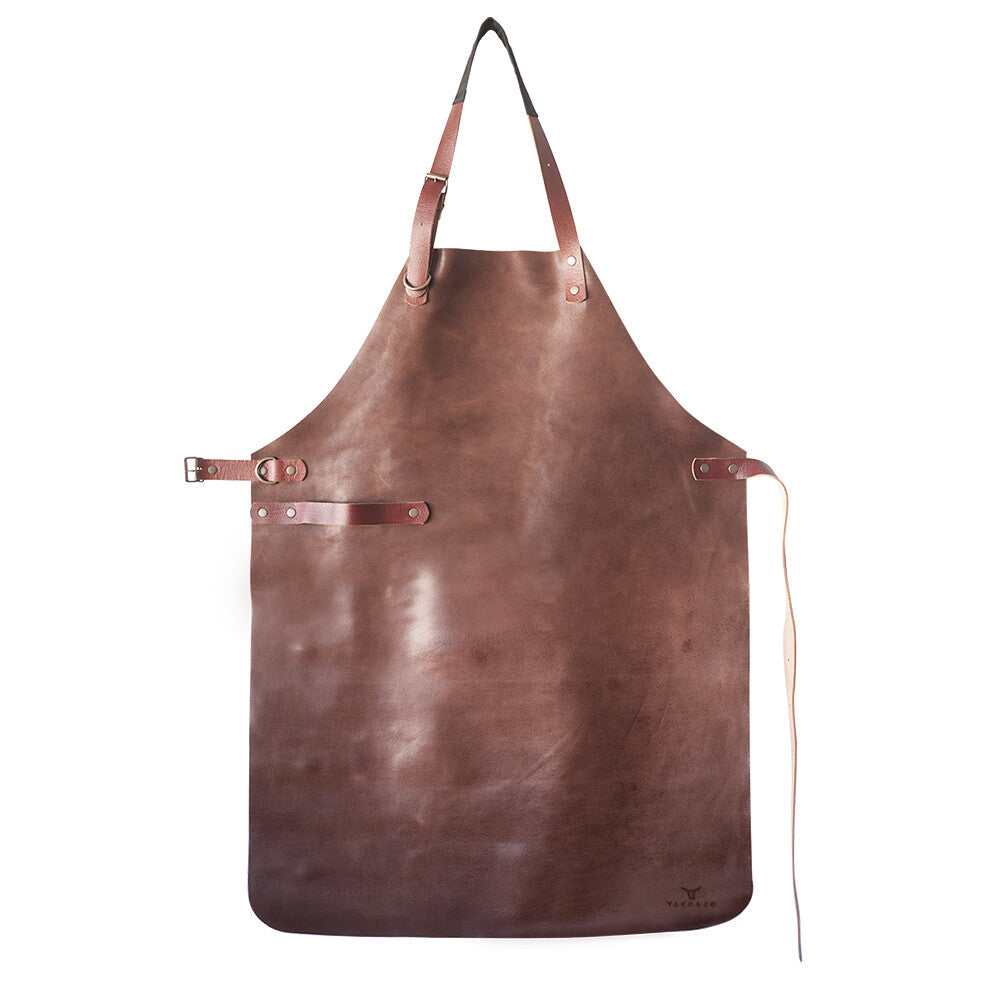 Leather Apron handcrafted from full-grain leather with adjustable straps, showcasing rich cognac tone and quality craftsmanship.