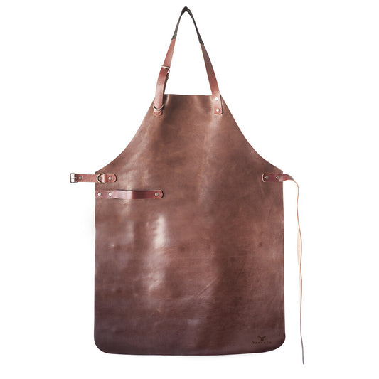 Leather Apron handcrafted from full-grain leather with adjustable straps, showcasing rich cognac tone and quality craftsmanship.