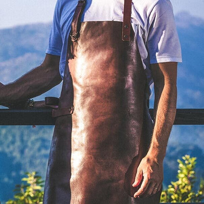 Man wearing a Leather Apron outdoors, showcasing its rich cognac color and adjustable straps.