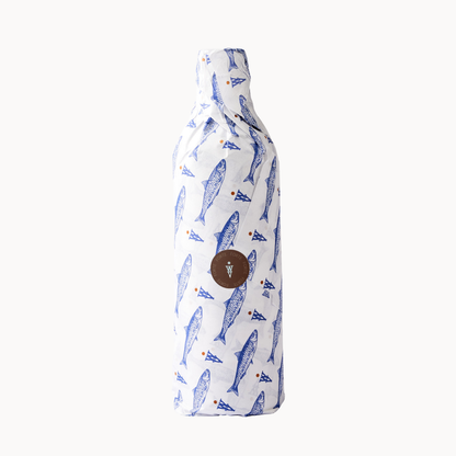 Bottle wrapped in fish-patterned paper, showcasing the artisanal packaging of Forte olive oil.