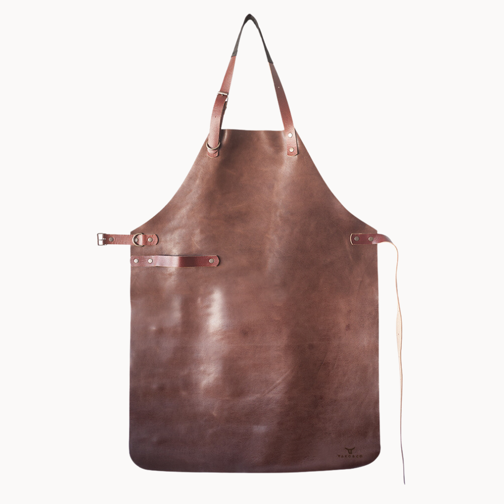 Leather Apron by Yako & Co showcasing full-grain leather with adjustable straps and logo detail.