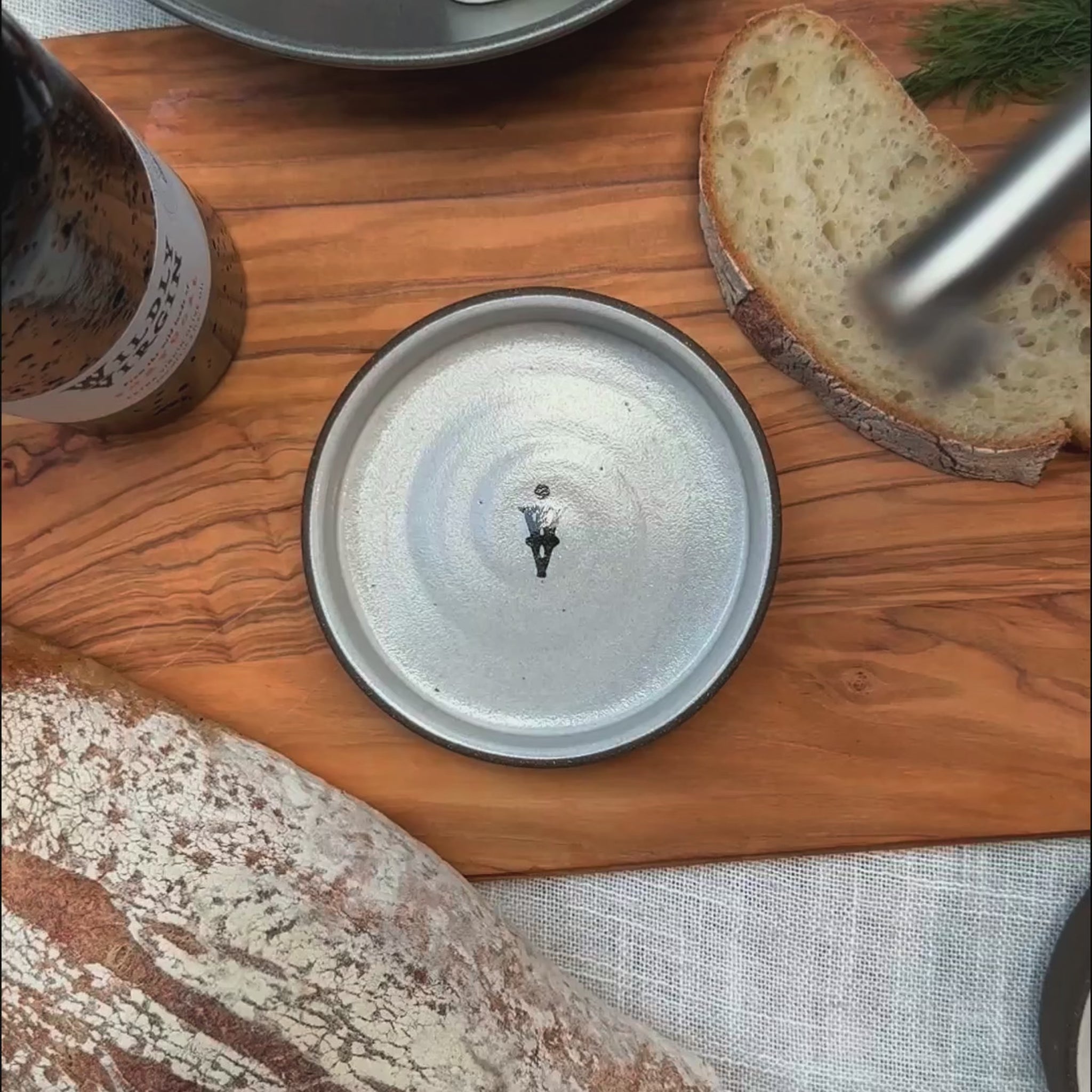 Tour of Portugal Gift Set featuring a hand-turned olive oil dish on a wooden board with bread and olive oil.