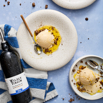 Doce drizzled over ice cream on a plate, showcasing its smooth and sweet qualities.